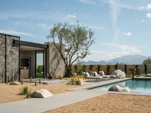 Modern residential pool area featuring concrete and glass elements.