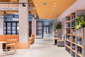 Modern interior of a library corridor featuring concrete and metal materials