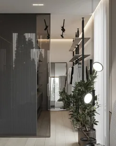 A modern interior design wardrobe with metallic accents, glass doors, and concrete flooring.