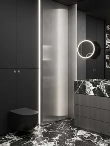 A modern bathroom with marble countertops and flooring, featuring dark cabinetry and a sleek, minimalist design.