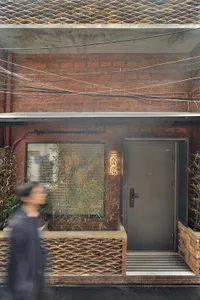 A brick and concrete exterior of an urban architectural structure.