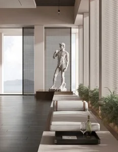 Modern living room with minimalist design, featuring concrete elements and a large statue of David.