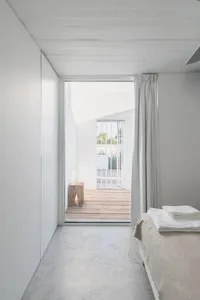 Minimalist bedroom featuring concrete and wooden elements