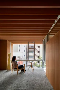 A minimalist living space featuring a wooden floor, natural light, and a serene atmosphere.