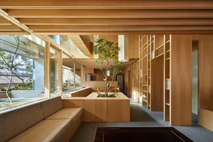 Modern interior design featuring a living area and library space, incorporating wooden elements.