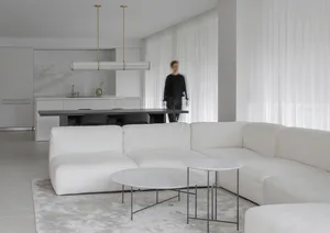 Living room with modern interior design featuring marble and white cotton blend furniture and accessories.