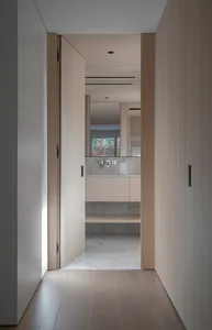 Modern minimalist bathroom featuring wooden elements and marble floor.