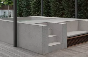 Modern outdoor bench with concrete structure and seating area.
