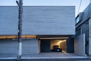 Modern car parked inside a minimalist concrete garage