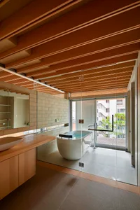 A modern bathroom features a glass shower door and a freestanding bathtub.
