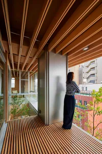 A modern interior space featuring timber flooring, glass walls, and minimalistic design.