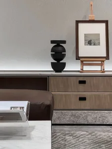 Modern living room with wooden furniture and abstract art on the wall.