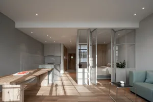 Modern minimalist living space featuring glass and wood materials.