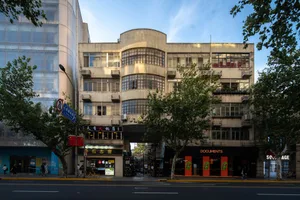 A street view showing a combination of concrete and glass building exteriors and storefronts.