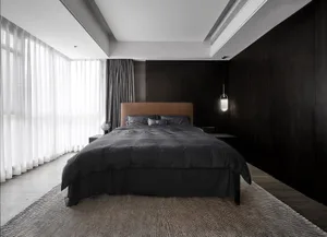Modern minimalist bedroom featuring black and white color scheme with textured cloth bedding and a large window.