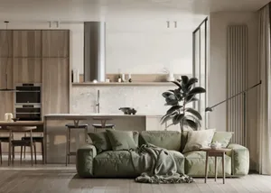 Minimalist living room with modern green upholstered couch, wooden flooring, and a modern kitchen area with wooden cabinets a