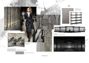 Model wearing a black outfit at a runway show with patterns and textures displayed in the background.