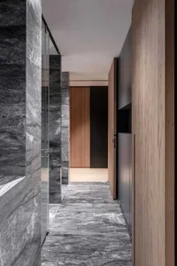 Modern interior design corridor featuring marble floor and concrete walls.