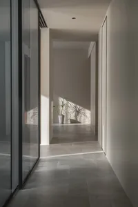 A minimalist modern interior space with concrete tile flooring.