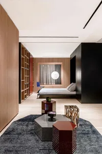 Modern minimalist bedroom featuring wooden panels, glass accents, and metal furniture.