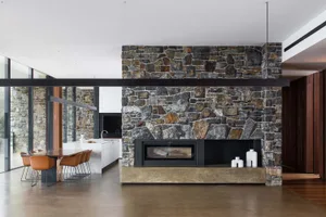 Modern minimalist room featuring a stone accent wall and a fireplace.