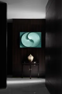 A modern entryway featuring minimalist metal circle artwork.
