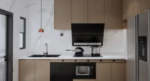 A modern kitchen with marble countertops and backsplash.