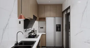 Modern kitchen with marble countertops and stainless steel appliances.