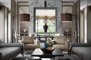 Modern living room with marble fireplace, leather chairs, and glass vases.