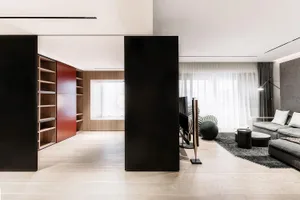 Modern living room designed with wood, metal, and fabric elements.