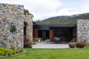 Modern residential exterior featuring stone landscaping.