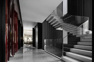 Modern residential staircase with concrete steps and glass railings.