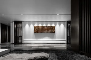 Modern lobby with metallic texture wall art in a contemporary interior design setting.