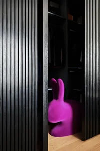 Modern purple bunny chair in a wooden closet