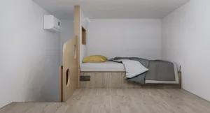 A minimalist bedroom featuring wooden furniture and a bed with a yellow pillow and grey blanket.