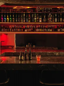 A bar counter with a dark, glossy marble top.