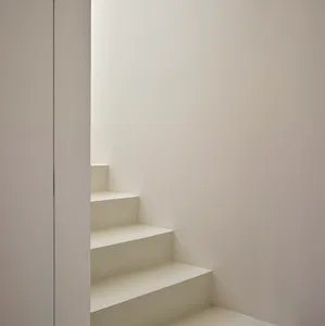 Concrete staircase with white walls in a minimalist interior design.
