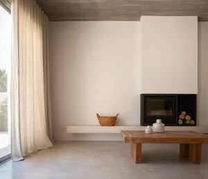 A minimalist living room with concrete walls, a wooden coffee table, and a built-in fireplace.