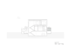 A detailed, 2D architectural drawing of a modern building's floor plan made on paper.