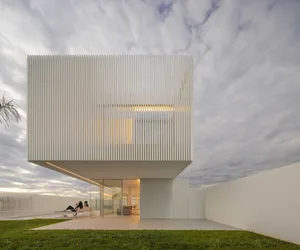 A modern house with metallic vertical blinds exterior design