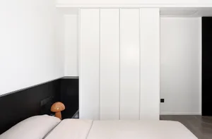A modern minimalist bedroom with white panels on the wall.