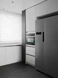 A contemporary kitchen with sleek metal appliances and minimalist design features.