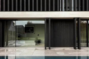 Modern outdoor living space featuring a sleek, contemporary pool deck constructed from concrete materials.