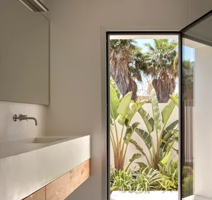 Minimalist bathroom with a concrete sink and wooden accents.