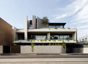 A modern building with concrete and glass exterior features.