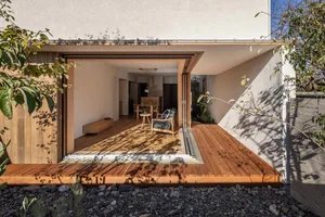 Modern exterior of a house with wooden panels and a wooden deck.