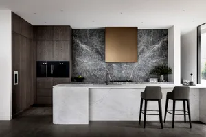 Contemporary residential kitchen featuring dark wood cabinets, a marble backsplash, and a marble kitchen island.