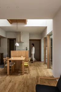A modern, minimalist kitchen featuring wooden elements and sleek design.