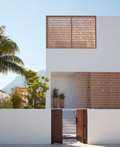 Modern minimalist residential house with concrete exterior and wooden elements.