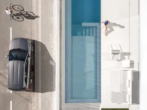 A modern poolside design featuring concrete and a car parked nearby.